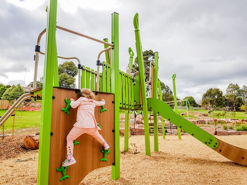 Child playing on a climbing wall at Sheahans Reserve Nature Playground