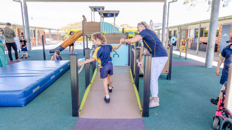 Child with carer on accessible ramp of Diabolo Multiplay unit