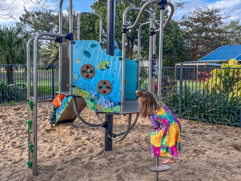 Girl climbing on play unit